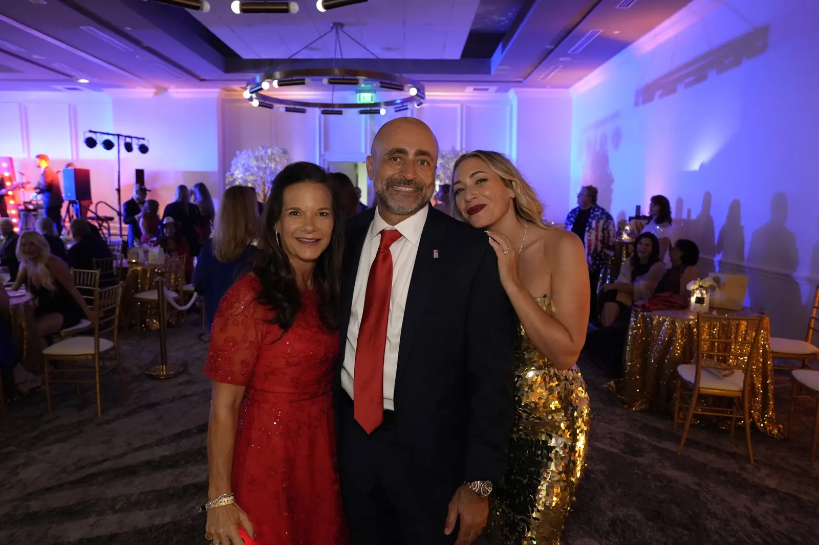 Guests photographed by Mark Studios at a Fourth of July gala at PGA National Resort in Palm Beach Gardens, July 2026. Posed portraits around the room are part of gala coverage, alongside the step-and-repeat and the program.