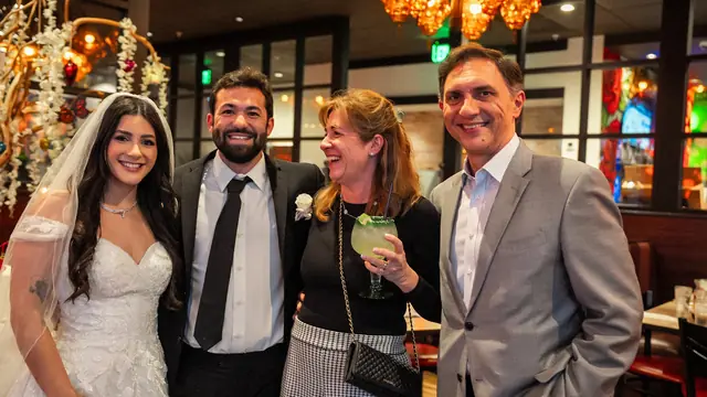 The couple with guests at their wedding reception